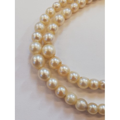 129 - A cultured pearl choker with diamond set clasp, comprising two rows of off-round cultured pearls, me... 