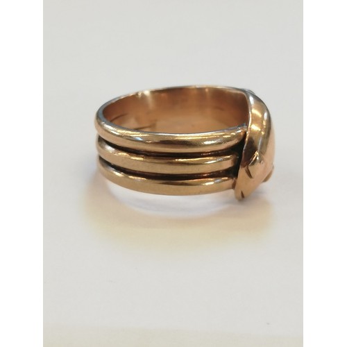 138 - A 9ct gold snake ring, the snakes head modelled with diamond shaped eyes and coiled tail to a reeded... 