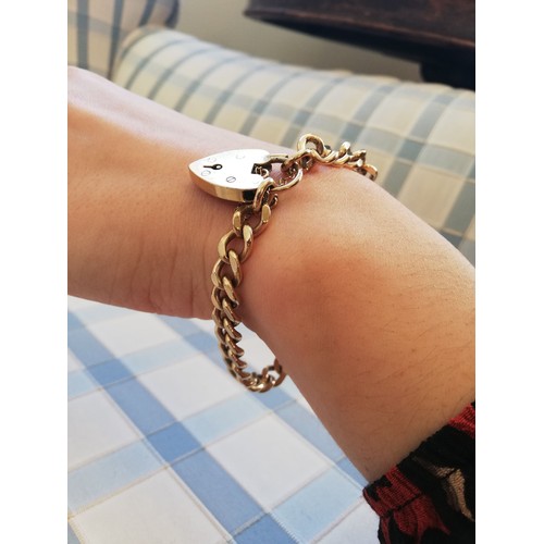 142 - A 9ct gold curb link bracelet, 20cm long, suspending a 9ct gold padlock fastening, marks for Cropp &... 