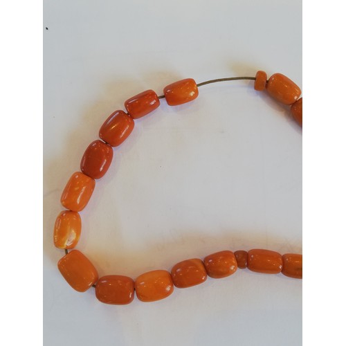 94 - An amber beaded necklace, designed as a row of cylindrical beads, measuring between 14.5mm x 10mm an... 