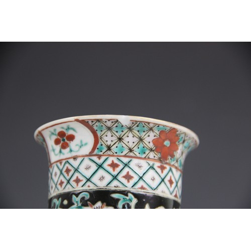 423 - A Chinese porcelain famille noir sleeve vase, 19th/20th century, of typical cylindrical form and dec... 