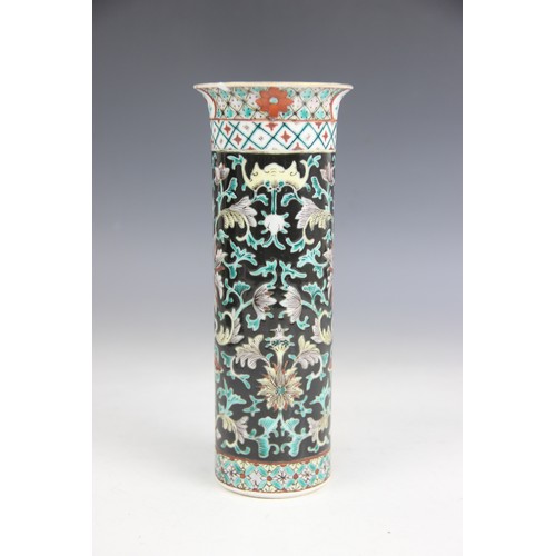 423 - A Chinese porcelain famille noir sleeve vase, 19th/20th century, of typical cylindrical form and dec... 