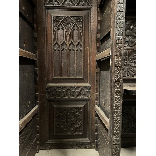 792 - A substantial 19th century carved oak sideboard back, profusely carved with flowerhead and geometric... 