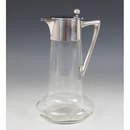 10 - A Christopher Dresser style German silver mounted cut glass claret jug by Wilhelm Binder, of baluste... 