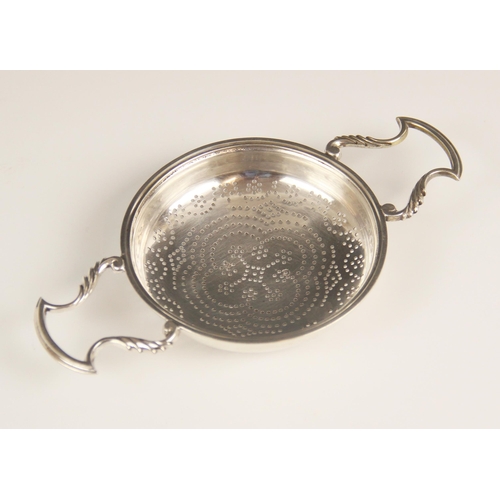 105 - A George II silver lemon strainer, London 1748 (maker's mark worn), the circular bowl with pierced d... 