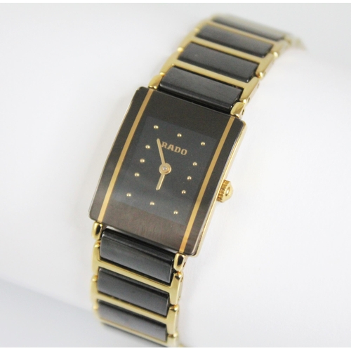 122 - A lady's Rado DiaStar wristwatch, the rectangular lack dial with gold toned dot markers, set to rect... 