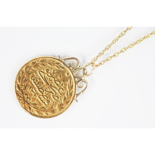 145 - A Turkish 100 Kurush coin, 23mm diameter, upon a gold coloured pendant mount, upon a fine 9ct gold c... 