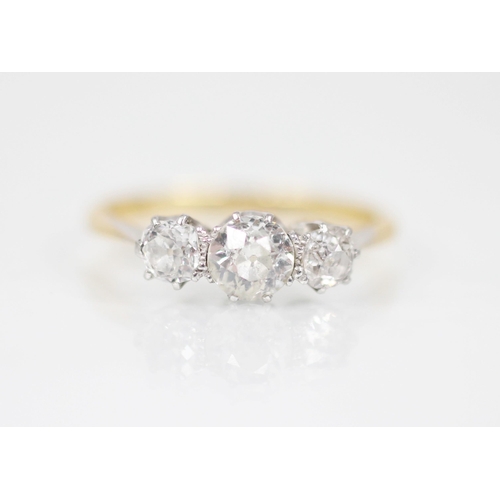 148 - A diamond three-stone ring, the central circular old cut diamond measuring approximately 5.2mm x 3mm... 