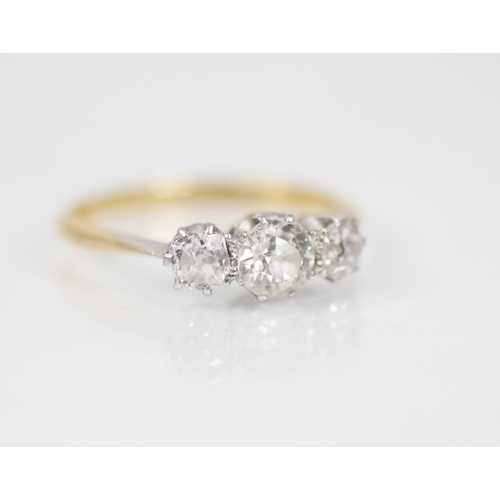 148 - A diamond three-stone ring, the central circular old cut diamond measuring approximately 5.2mm x 3mm... 