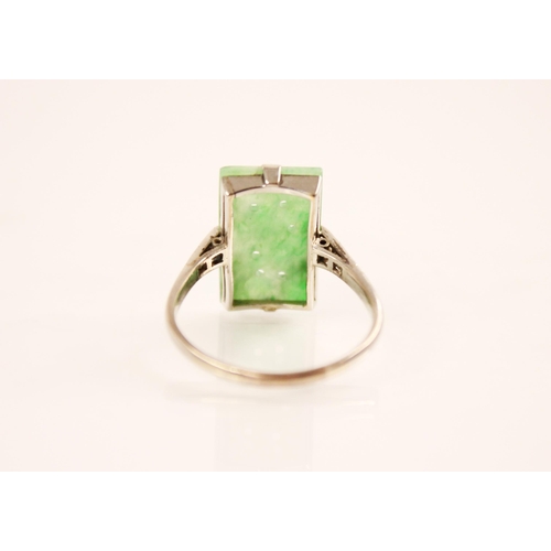 156 - An Art Deco jade and diamond ring, the central rectangular carved and pierced jade panel measuring 1... 