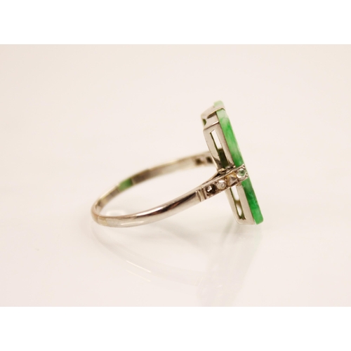 156 - An Art Deco jade and diamond ring, the central rectangular carved and pierced jade panel measuring 1... 