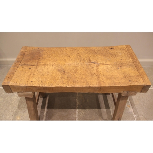 751 - A sycamore butchers block, late 19th/early 20th century, of gnarled and worn rectangular form, raise... 