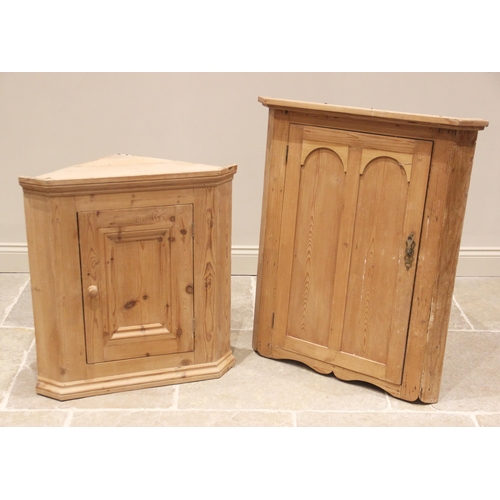 754 - A Victorian style pine hanging corner cupboard, the moulded cornice above a single panelled door ope... 