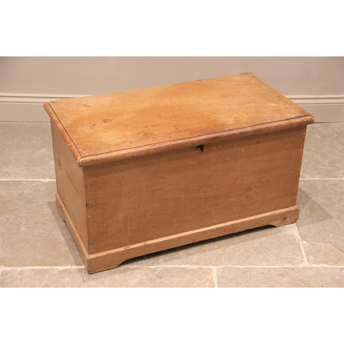 755 - A Victorian pine blanket chest, the hinged cover opening to a fitted candle box, raised upon a plint... 