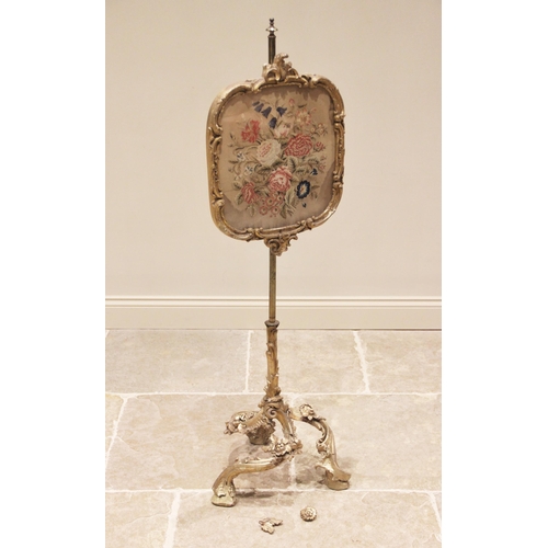 759 - A late 19th century gilt gesso and brass pole screen, the tapestry work glazed panel within a 'C' sc... 