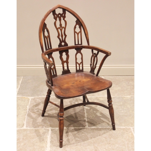 767 - An oak and ash Gothic revival Windsor chair, the pointed arched back with pierced and interlaced spl... 