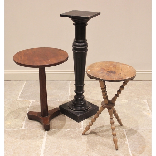 769 - A 19th century ebonised torchere, the square top raised upon a fluted and ring turned tapering colum... 