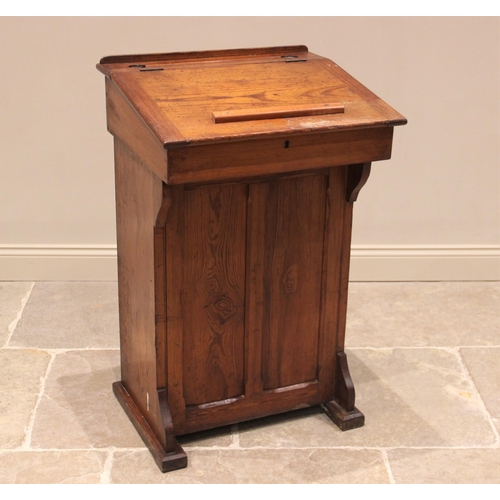 783 - A Victorian pitch pine lectern, the hinged slope above a hinged front panel opening to two fixed she... 