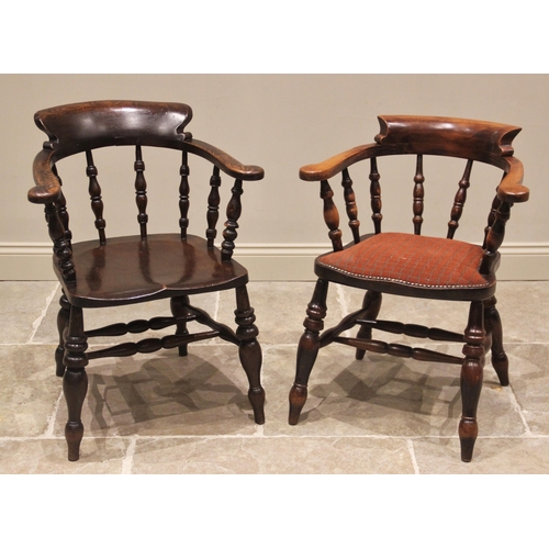 789 - A Victorian stained elm smokers bow elbow chair, the curved top rail raised upon turned baluster spi... 