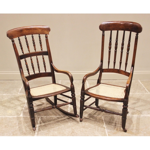 793 - A 19th century beech and fruit wood rocking chair, the spindled back above a rattan seat, raised upo... 