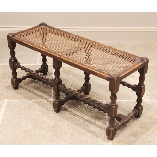 809 - An oak and rattan long stool/window seat, early 20th century, the rectangular cane work seat raised ... 