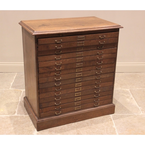 811 - An early 20th oak map chest, the rectangular moulded top above fifteen drawers applied with angular ... 