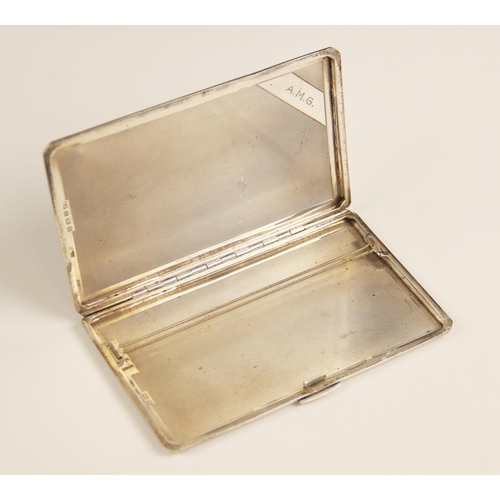 52 - A George VI silver cigarette case, A Wilcox, Birmingham 1949, of rectangular form with engine turned... 