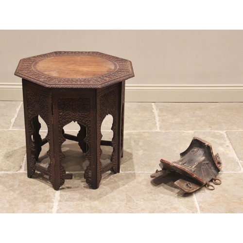 772 - A late 19th century Anglo-Indian carved hardwood octagonal table, the top carved with a foliate card... 