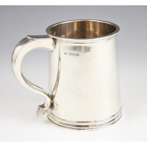25 - A George IV silver tankard, Adie Brothers, Birmingham 1948, of tapering cylindrical form of raised b... 