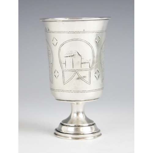 69 - A Kyiv or Kiev silver toddy cup, of cylindrical form with flared rim upon pedestal foot, engraved wi... 