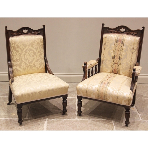 794 - A pair of Victorian ladies and gentleman's walnut and upholstered armchairs, the serpentine top rail... 