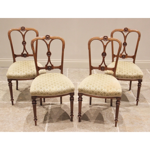 795 - A set of four Victorian walnut salon chairs, by 'Urquhart and Adamson, Liverpool', each with a rail ... 