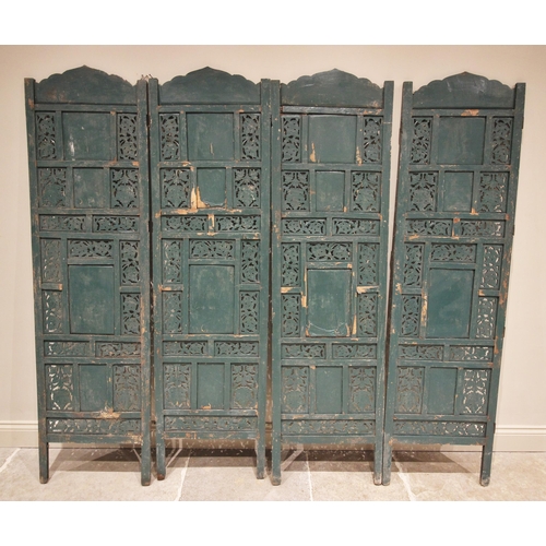 774 - A painted hardwood Indian four panel room screen, each panel constructed from an arrangement of carv... 