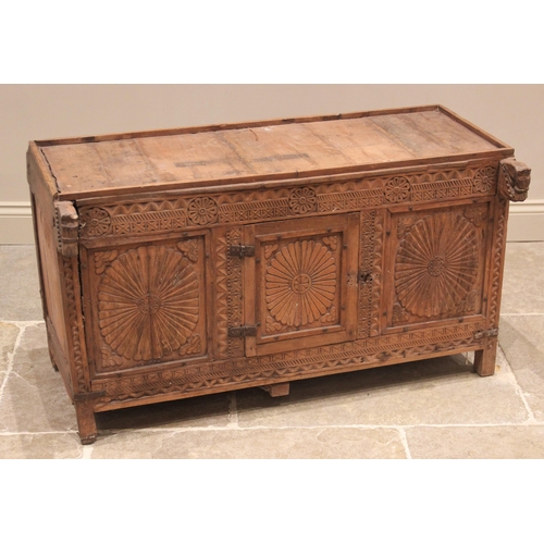 775 - An Indian carved hardwood dowry chest, late 19th/early 20th century, the galleried plank top above a... 