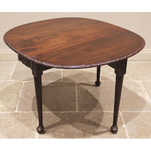 796 - A George III mahogany drop leaf table, possibly Irish, the moulded oval top with a lunette carved ri... 