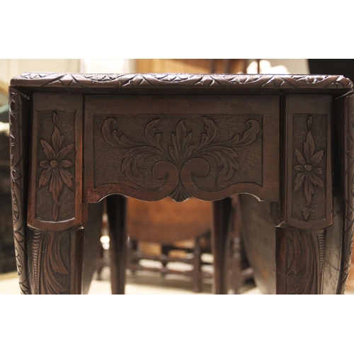 796 - A George III mahogany drop leaf table, possibly Irish, the moulded oval top with a lunette carved ri... 