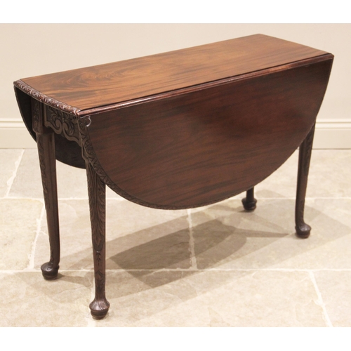 796 - A George III mahogany drop leaf table, possibly Irish, the moulded oval top with a lunette carved ri... 