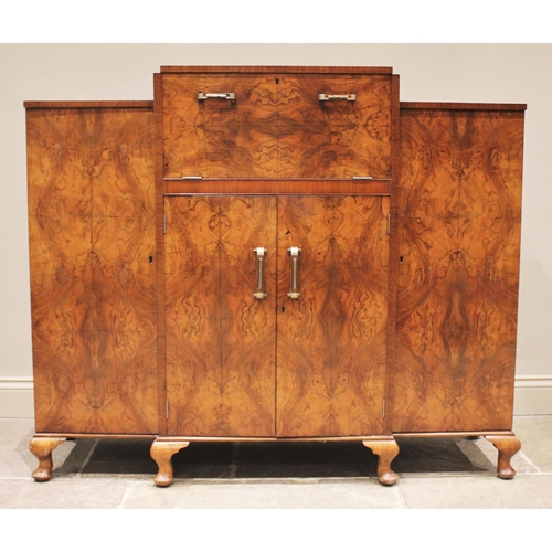 798 - A 1930's figured walnut cocktail 'Hospitality Cabinet', of angular form, the central fall front encl... 