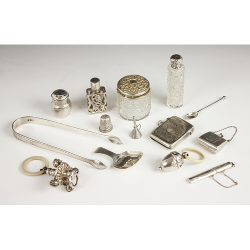 97 - A selection of silver and silver coloured accessories, to include an Edwardian novelty silver rattle... 