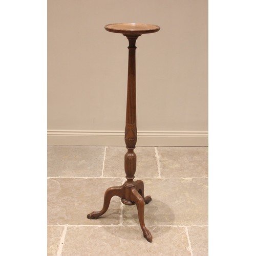 755A - A 19th century style oak torchere, early 20th century, the circular tray top upon a reeded tapering ... 