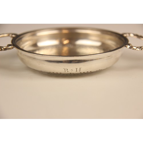 105 - A George II silver lemon strainer, London 1748 (maker's mark worn), the circular bowl with pierced d... 