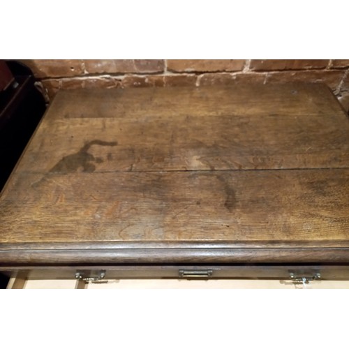 811 - An early 20th oak map chest, the rectangular moulded top above fifteen drawers applied with angular ... 