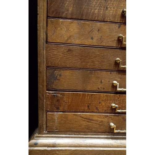 811 - An early 20th oak map chest, the rectangular moulded top above fifteen drawers applied with angular ... 