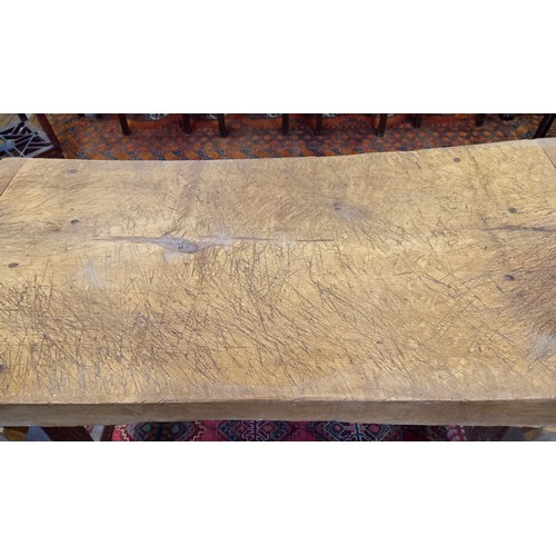 751 - A sycamore butchers block, late 19th/early 20th century, of gnarled and worn rectangular form, raise... 