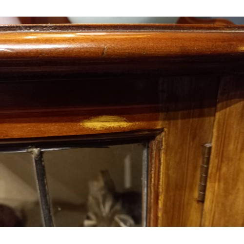 806 - An Edwardian mahogany display cabinet, with a shaped rear gallery above a bowfront leaded and colour... 