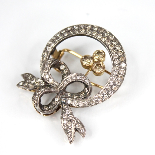 100 - A Victorian and later diamond set wreath brooch, designed as a circular wreath with bow fastening, s... 