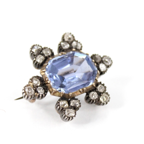 101 - A Victorian sapphire and diamond cluster brooch, the central rectangular mixed cut sapphire with can... 