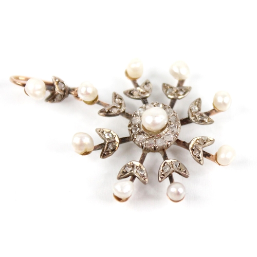 103 - An Edwardian pearl and diamond snowflake pendant, designed as a central off-round pearl with a borde... 