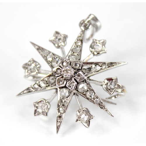 107 - A diamond starburst pendant brooch, the tiered six pointed star set throughout with rose cut diamond... 