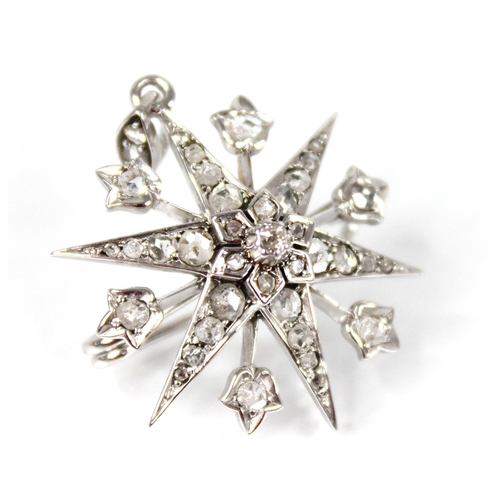 107 - A diamond starburst pendant brooch, the tiered six pointed star set throughout with rose cut diamond... 